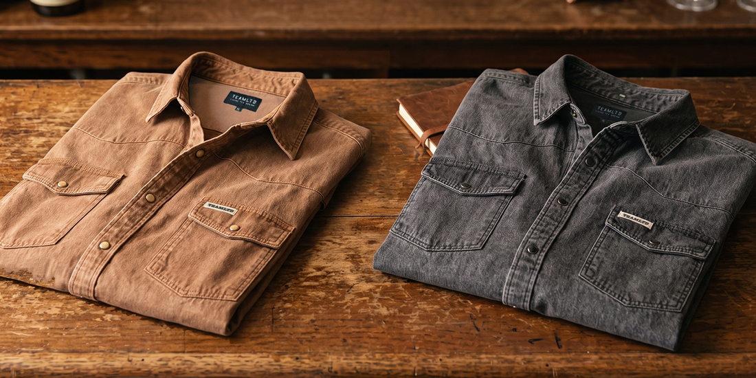 TEAMLTD Homestead Denim Button Up in Saddle and Washed Black folded on a wooden table